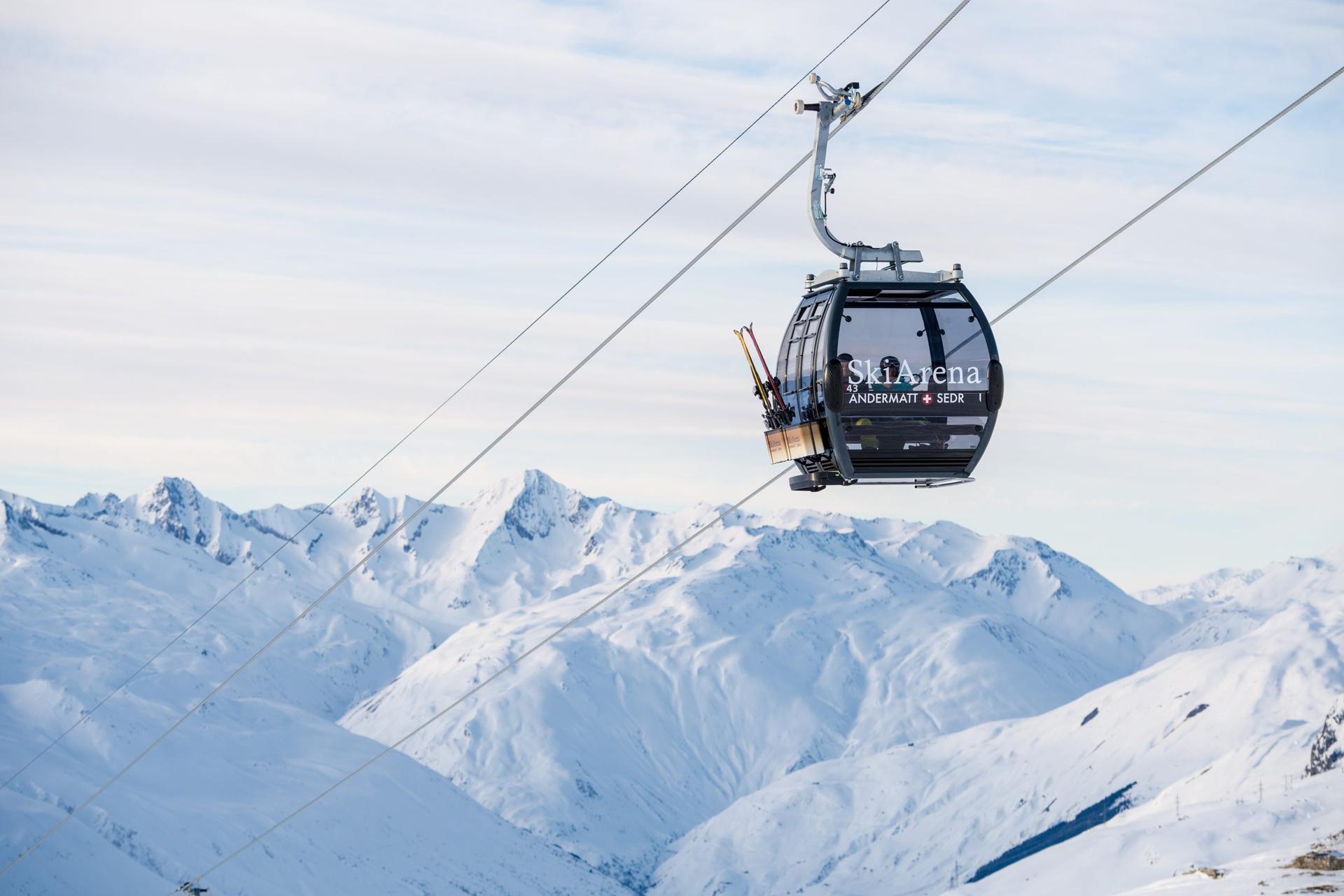 Gondola in Swiss mountains of Andermatt ski reosrt transporting skiers to top of mountain