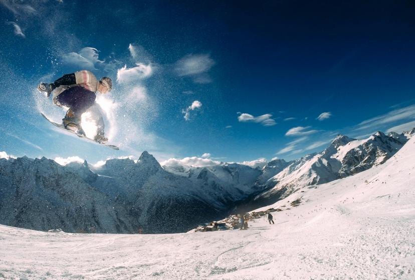 https://a.storyblok.com/f/150663/3902x2635/882d07c578/snowboarder-with-skiers-in-the-mountains.jpg