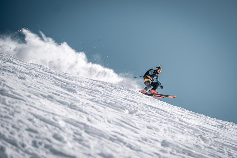 Skier skiing fast down slope